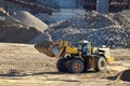 Large heavy front-end loader or all-wheel bulldozer for mechanization of loading, digging and excavation operations in open quarry Royalty Free Stock Photo