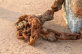 Large heavy rusy chain laying on a beach