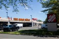 Large Home Depot sign with blue sky a cars