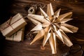 A large homemade Christmas star near a stack of hand-wrapped gifts in recycled wrapping paper. Vintage Christmas Royalty Free Stock Photo