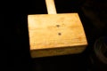 Large homemade wooden hammer with a square head. Mallet. Front view.Low key Royalty Free Stock Photo