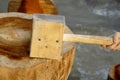 Large homemade wooden hammer with a square head. Mallet. Low key. Side view