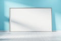 Large horizontal frame leaning on a blue wall 3D rendering Royalty Free Stock Photo