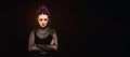 Large horizontal image Woman with halloween makeup on dark backgroundcolored, looking to the side, goth feel, space for copy