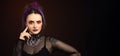 Large horizontal image Woman with halloween makeup on dark backgroundcolored, looking to the side, goth feel, space for copy