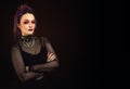 Large horizontal image Woman with halloween makeup on dark backgroundcolored, looking to the side, goth feel, space for copy