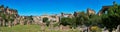 Large horizontal panorama with view of the Roman Forum showcasing the Tabularium, the Arch of Septimius Severus, the Temple of