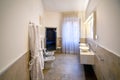 A large hotel bathroom with walk-in shower, bidet, toilet and double pedastal sinks Royalty Free Stock Photo