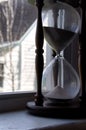 Large hour glass on a window sill