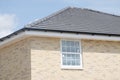 Large house being built on luxury housing development showing roof walls and a window