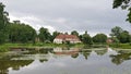 Large house on the shore of a small Jaunpils reservoir in the town. Latvia, July 2019