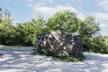 A large, huge stone megalith with a staircase against the background of green trees and a blue sky, used as an observation deck Royalty Free Stock Photo