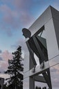 Large human statue with modern architecture in google campus during sunset