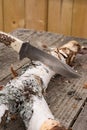 Large hunting knife stuck in log