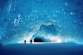 Large ice cave with tunnel and people inside in winter. Royalty Free Stock Photo
