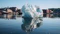 a large iceberg in water with buildings in the background