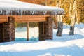 Large icicles hang from a house roof. Dangerous large icicles Royalty Free Stock Photo