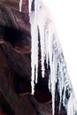 Large icicles on the roof of the house in sunny weather