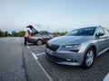 Large IKEA furniture parking with two Skoda cars Octavia and Superb parked in the evening - woman loading goods in trunk