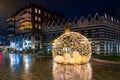 Large illuminated Christmas bauble on a town square