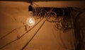 large incandescent lamp among the wires of the old wiring Royalty Free Stock Photo