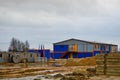 A large industrial barn warehouse and modular buildings for workers at the open-air construction site warehouse Royalty Free Stock Photo