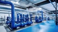 Large industrial boiler room and water treatment facility, blue pumps, shiny stainless metal pipes, and valves Royalty Free Stock Photo