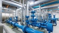 Large industrial boiler room and water treatment facility, blue pumps, shiny stainless metal pipes, and valves Royalty Free Stock Photo