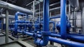 Large industrial boiler room and water treatment facility, blue pumps, shiny stainless metal pipes, and valves Royalty Free Stock Photo