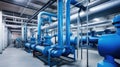 Large industrial boiler room and water treatment facility, blue pumps, shiny stainless metal pipes, and valves Royalty Free Stock Photo
