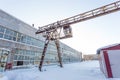 Large industrial building in abandoned factory area with rusty lift Royalty Free Stock Photo