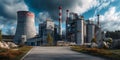 A large industrial complex with towering structures and pipes, illuminated under a dramatic sky. The image captures the scale and Royalty Free Stock Photo
