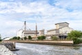 Large industrial factory building side canal and aqueduct water bridge across road for drainage to sea with beautiful blue sky at Royalty Free Stock Photo