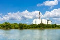 Large industrial factory and silo building at side coast of sea with blue sky and cloud in bright day