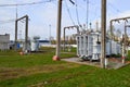 Large industrial iron metal transformer substation with transformers and high-voltage electrical equipment and wires with surge Royalty Free Stock Photo