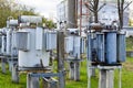 Large industrial iron metal transformer substation with transformers and high-voltage electrical equipment and wires with surge Royalty Free Stock Photo