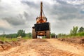 A large industrial loader equipped with a crane mounted on top, ready for heavy lifting and construction work at a construction Royalty Free Stock Photo