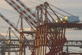 Large industrial loading cranes against a cloudy sky