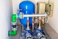 Large industrial water treatment and boiler room. Shiny steel metal pipes and blue pumps and valves. interior of a modern gas boil Royalty Free Stock Photo