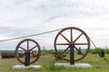 Large Industrial Wheels Holding a Cable