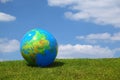 Large inflatable globe lies on grass