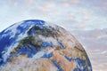 Large inflatable model of planet Earth, detail on Europe, small pink sunset clouds in background Royalty Free Stock Photo