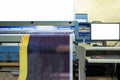 Large inkjet printer working on vinyl banner with computer