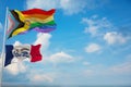 large Inter Progress Pride flag and flag of Iowa state, USA waving at sky. Freedom and love, activism, community concept. Pride