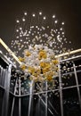 A large interior chandelier made of glass balls of white and green color. glass balls hanging from threads from the ceiling. Royalty Free Stock Photo