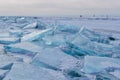 Large iridescent crystals blue white ice floes with cracks glow in the light of the sun, lake baikal in winter