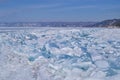 Large iridescent crystals white blue ice floes with cracks glow in the light of the sun, lake baikal in snow Royalty Free Stock Photo