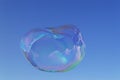 Large iridescent soap bubble with oval shape