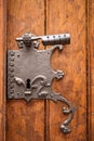 Large iron antique lock with handle and keyhole on a wooden old door from planks
