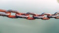 Old rusty chain lying on the gray background Royalty Free Stock Photo